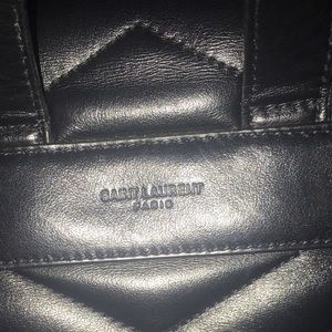 Black medium YSL LULU backpack. 100% authentic. Inside has 3 pockets.